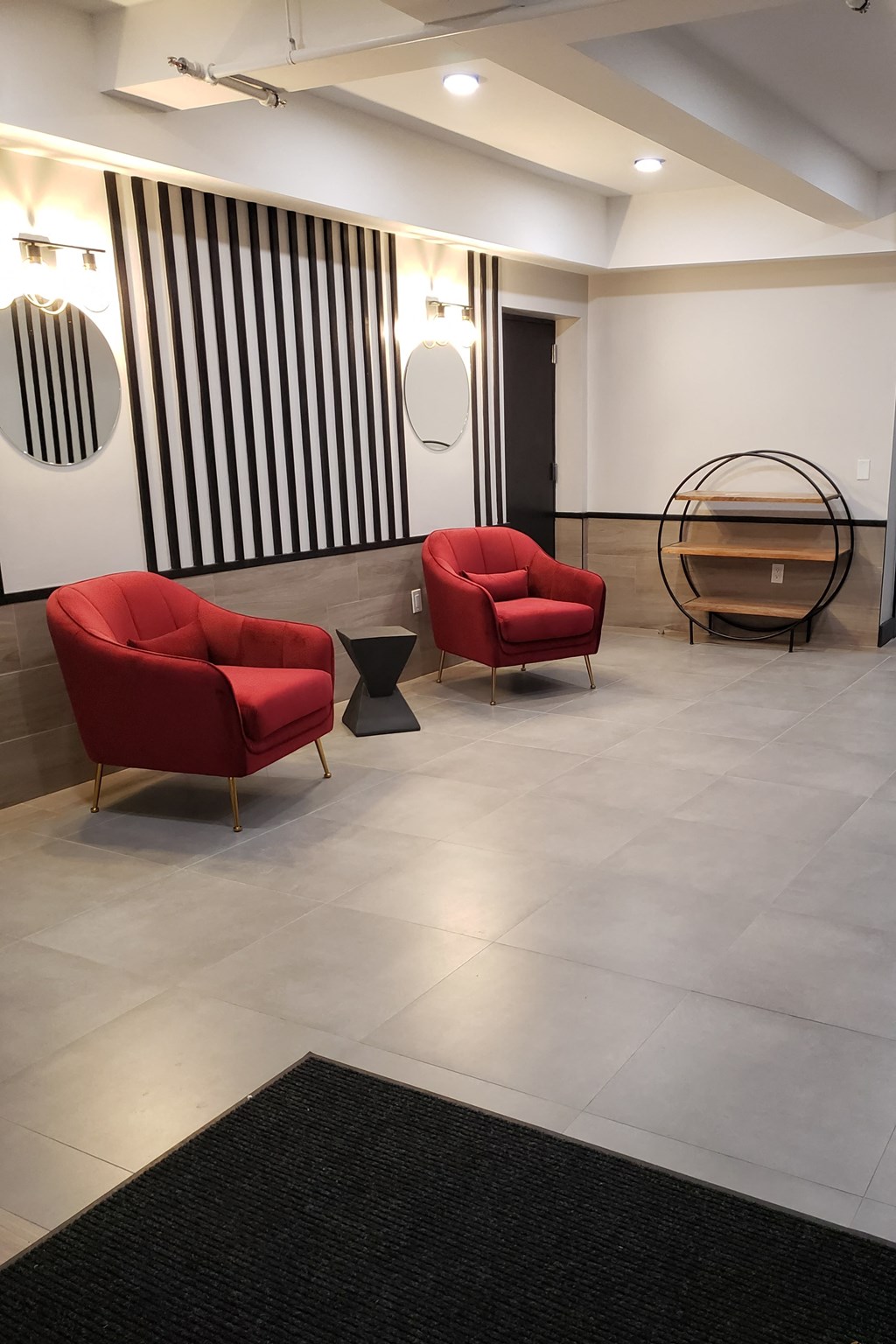 a living room with two red chairs and a table