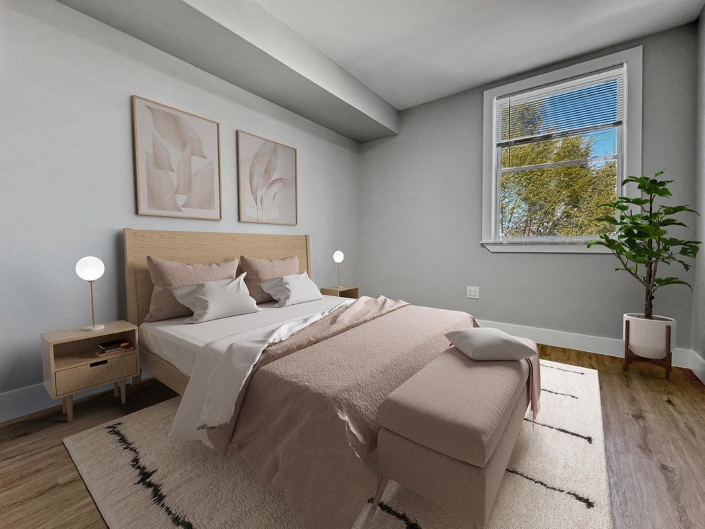 a bedroom with a bed and a large window