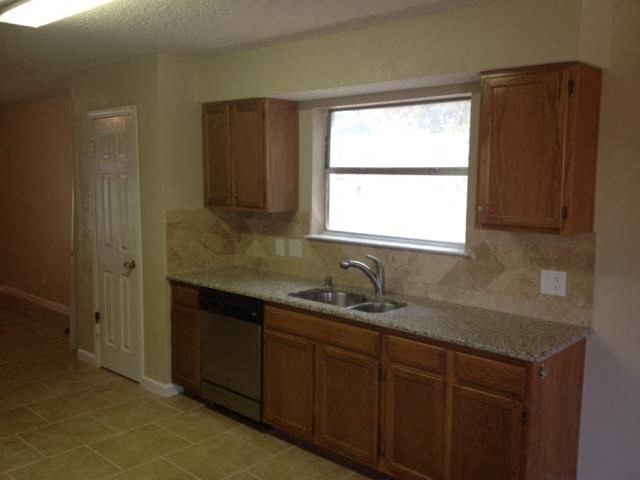 a kitchen with a sink and a window