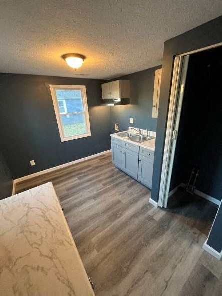 A kitchen with a sink and a window.