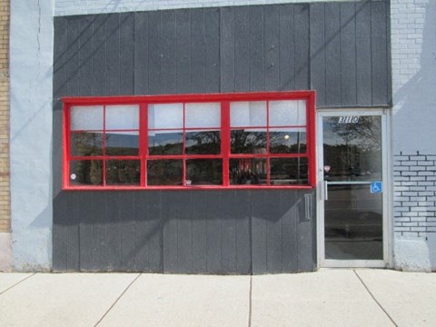 A red window on a grey building.