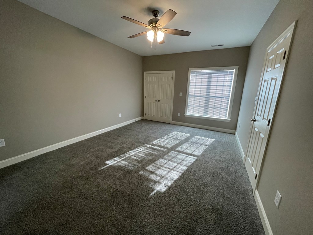 A room with a carpet that has a white design on it.