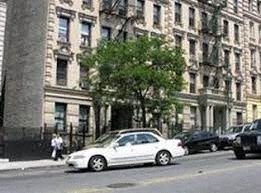 A white car is parked on the side of a street.