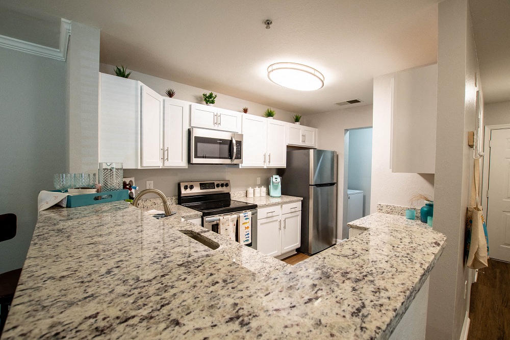 a kitchen with granite counter tops and stainless steel appliances