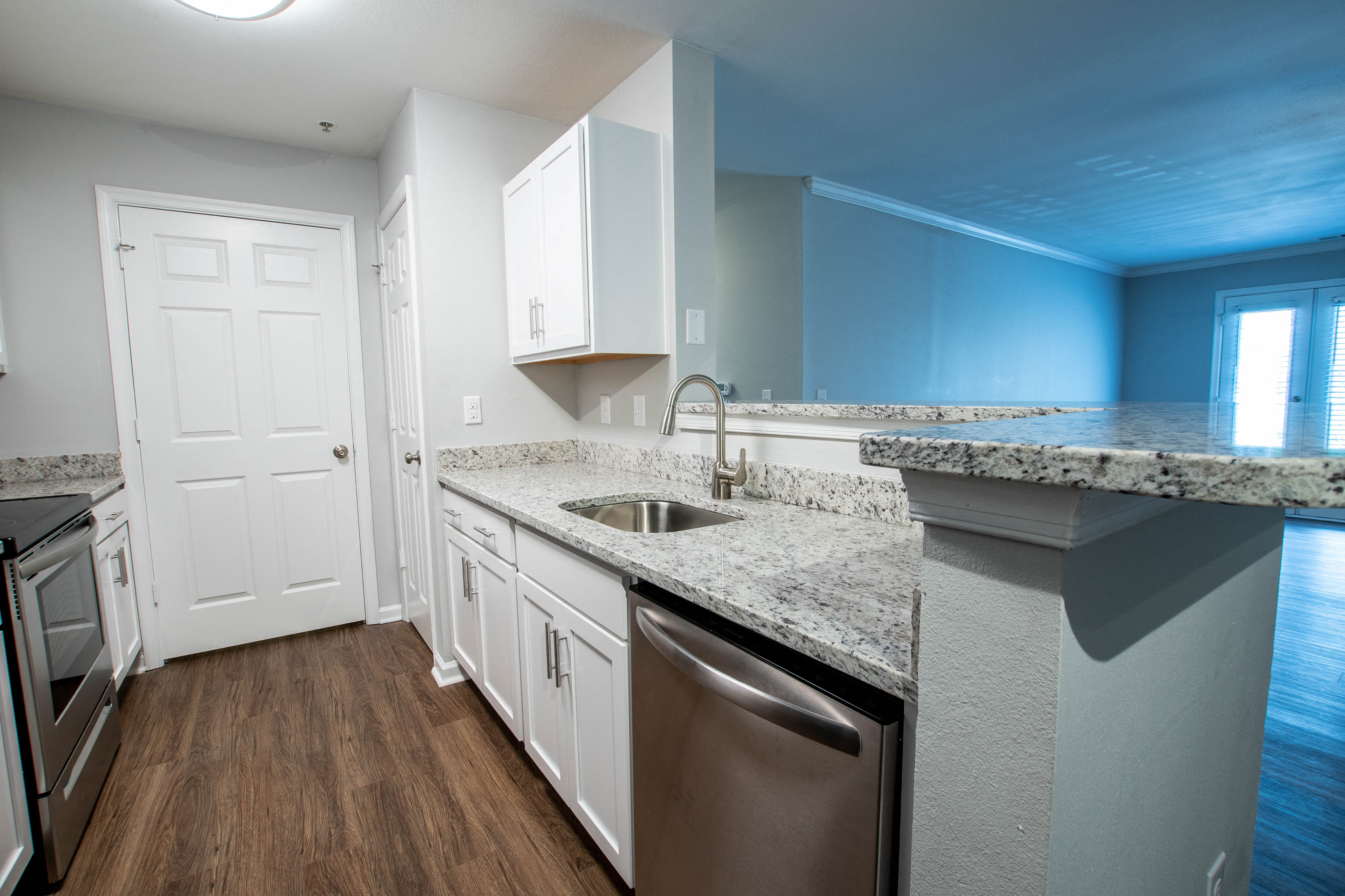 an empty kitchen with granite counter tops and stainless steel appliances