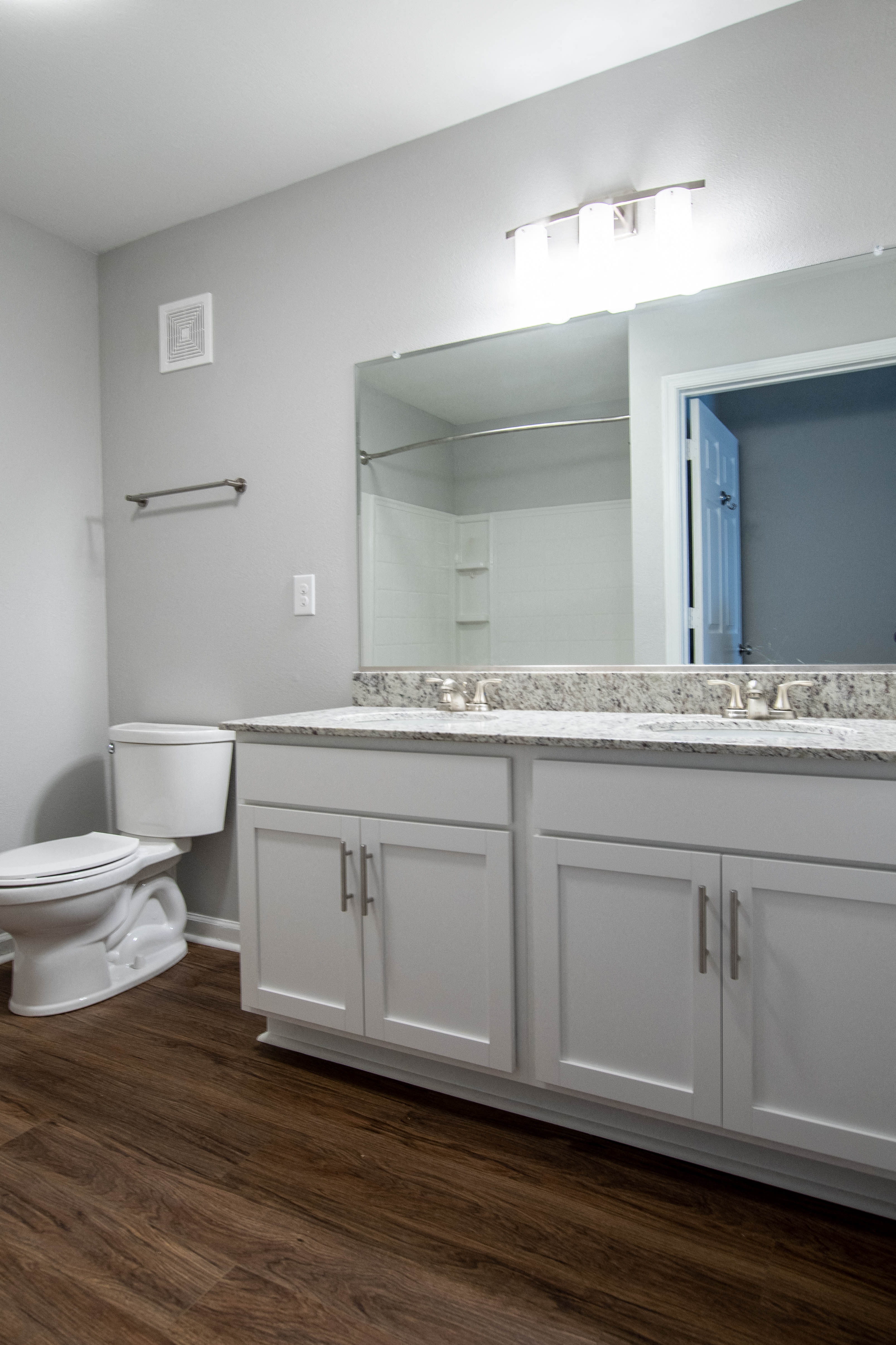 a bathroom with a toilet and a sink and a mirror