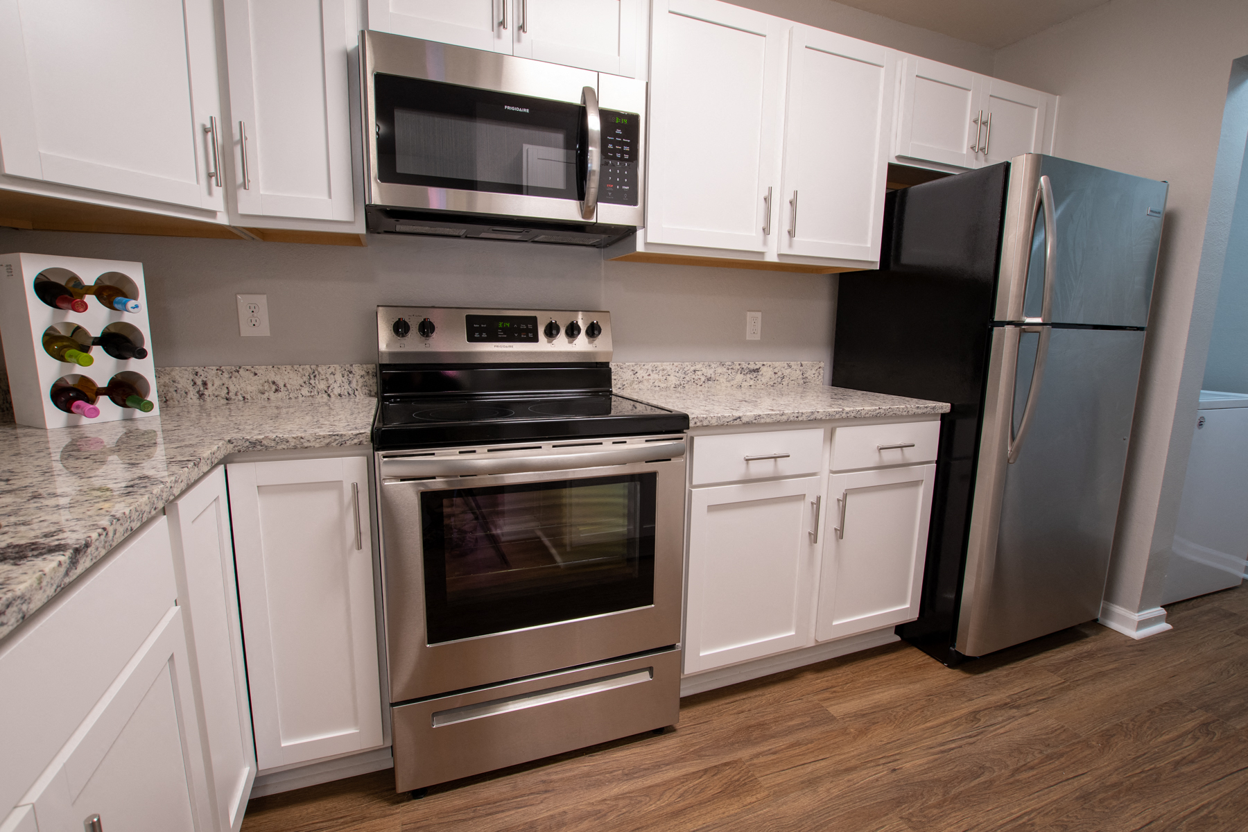 a kitchen with stainless steel appliances and white cabinets