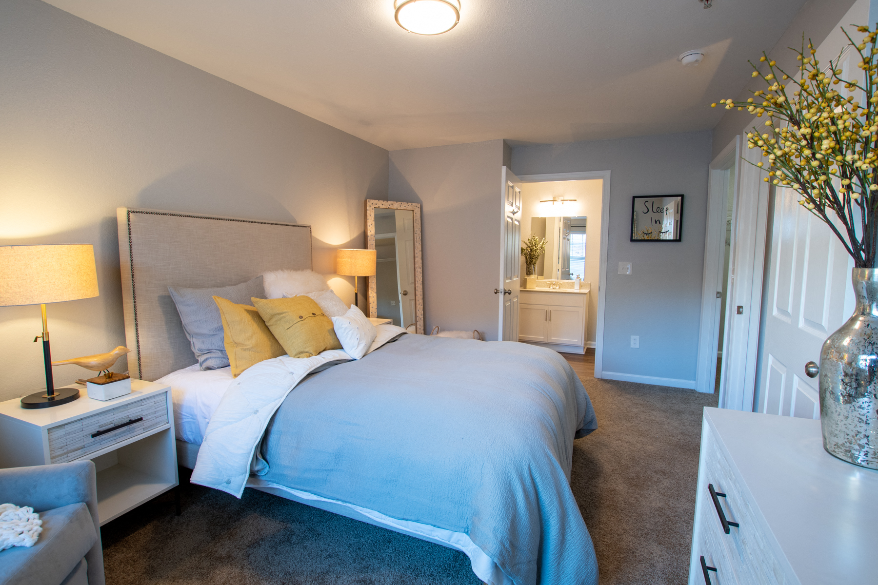 a bedroom with a large bed and a bathroom