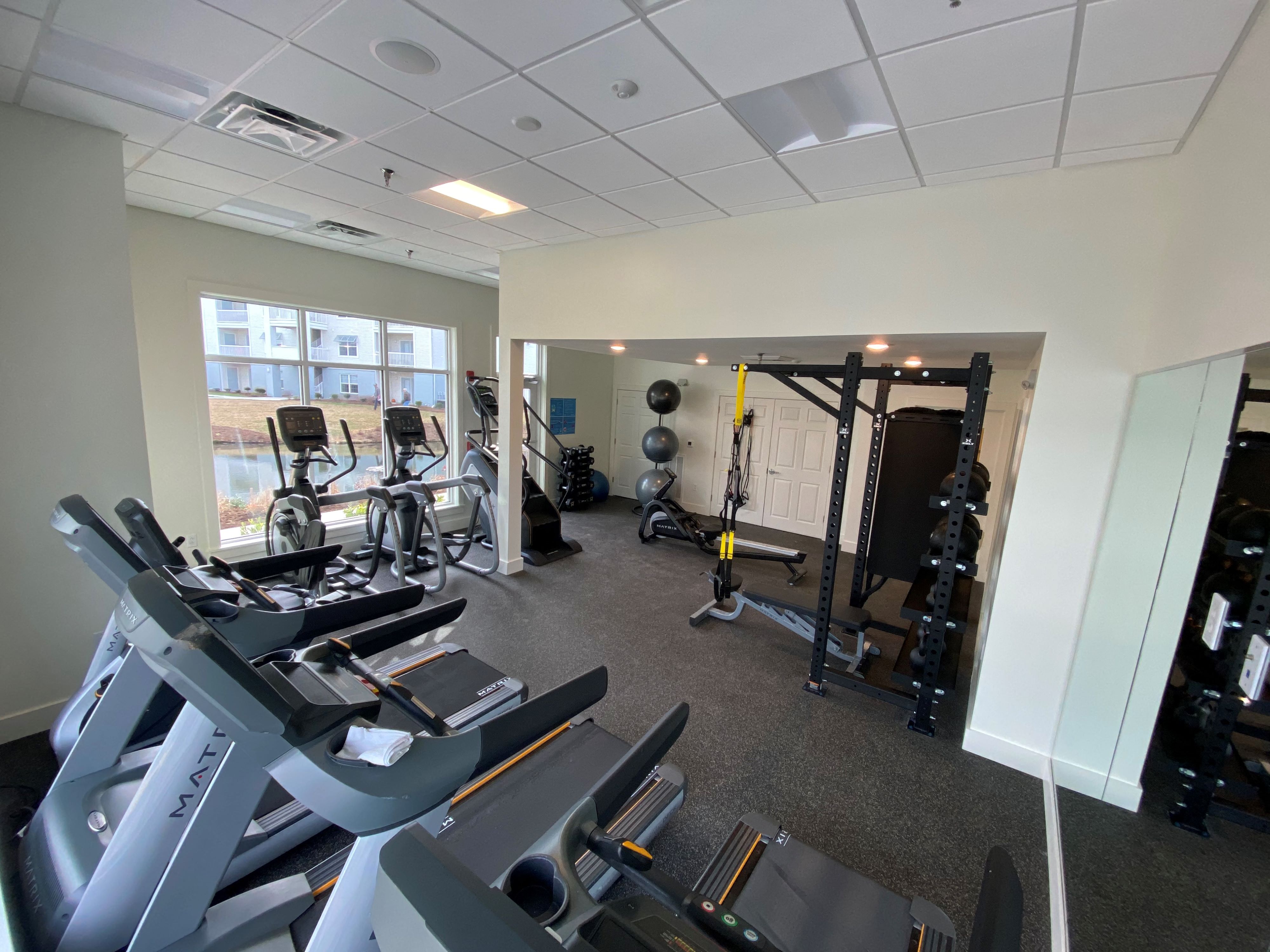 a gym with cardio machines and other exercise equipment