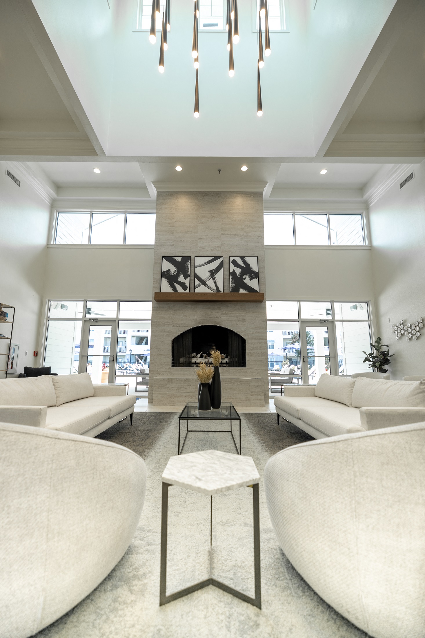 a living room with white couches and a fireplace