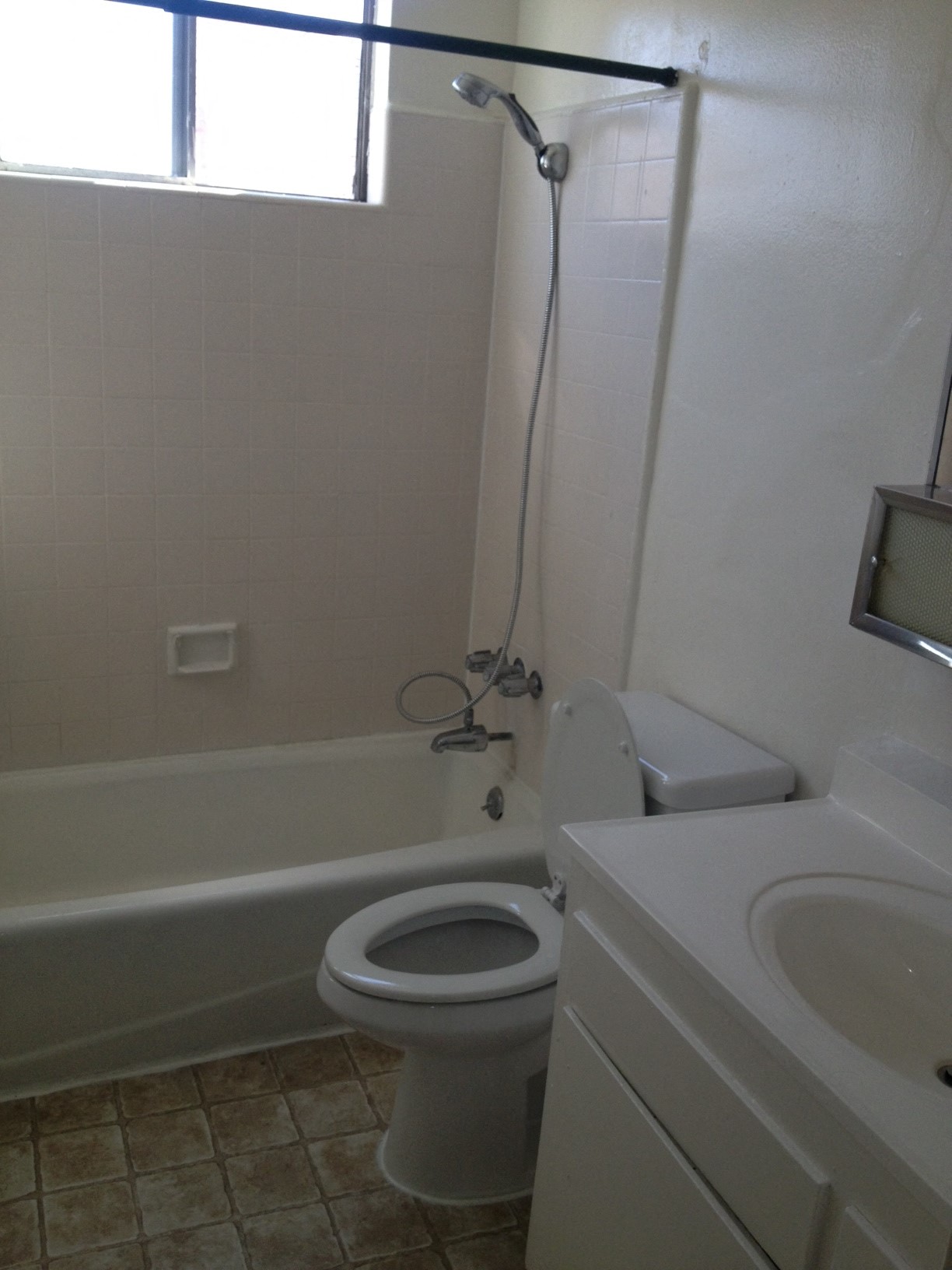 a bathroom with a toilet and a tub and a sink