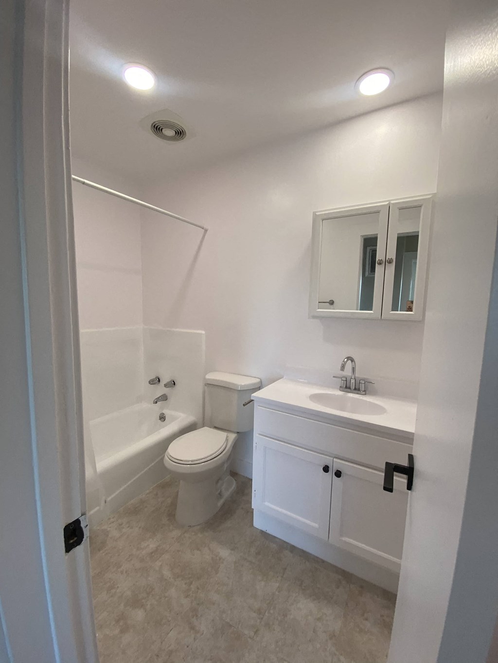 a small bathroom with a sink toilet and bath tub