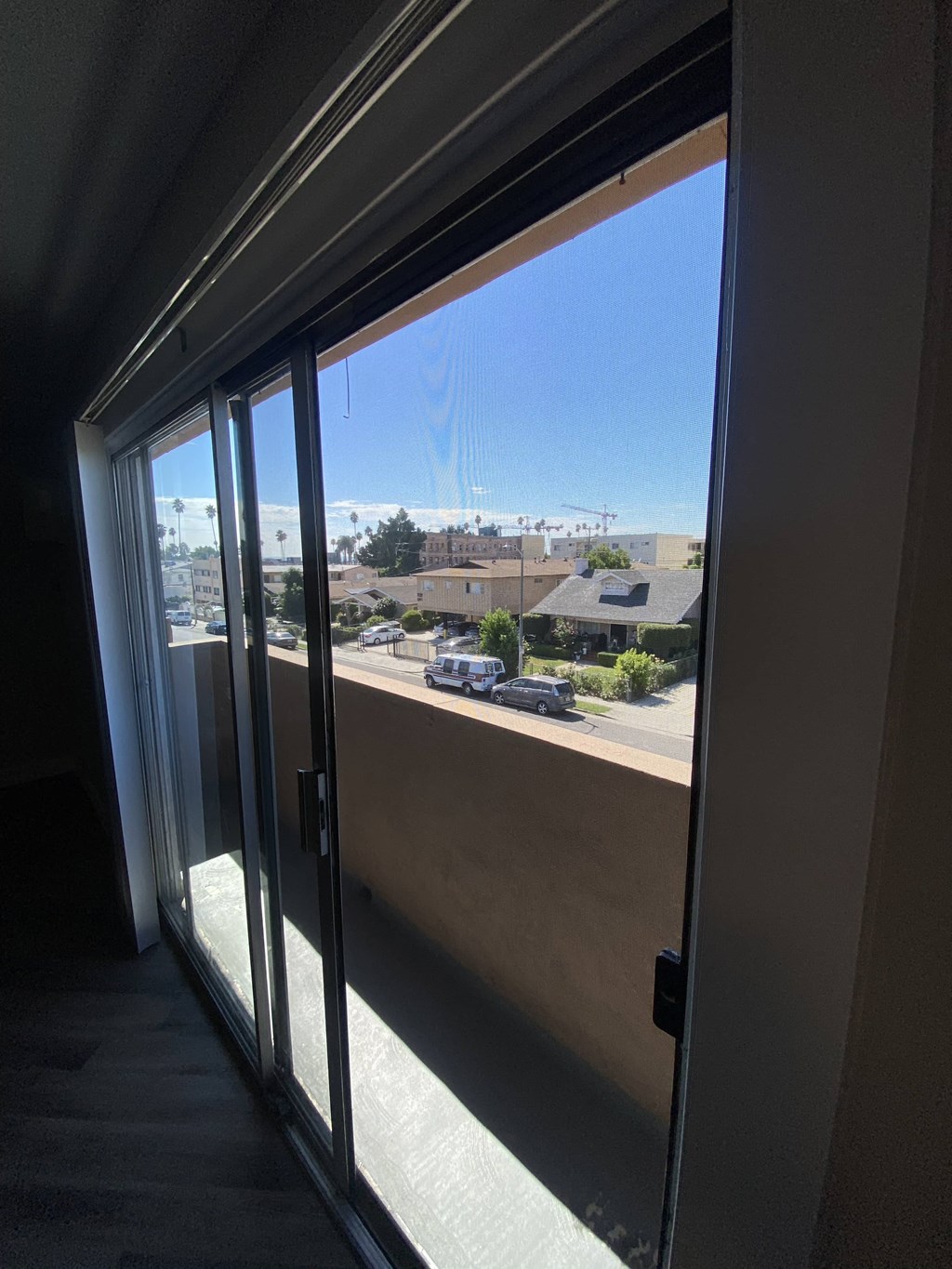 a sliding glass door with a view of a parking lot
