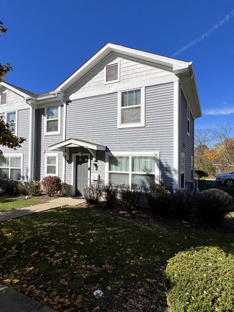a white house with a blue sky in the background