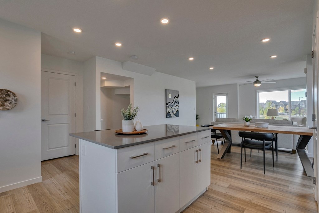 an open kitchen and dining area with a large island and a dining room table