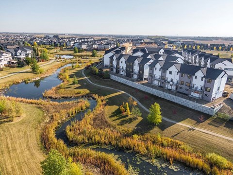 an aerial view of houses next to a river