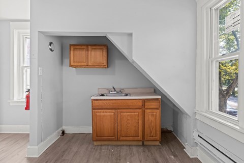 A kitchen with wooden cabinets and a window.