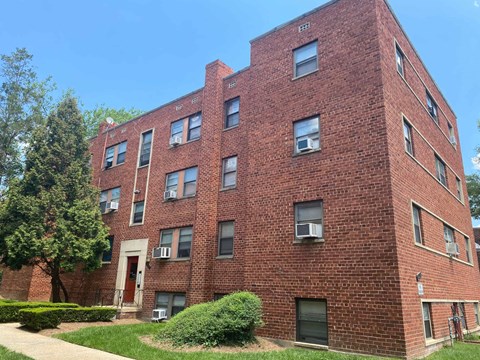 a red brick apartment building on a sunny day