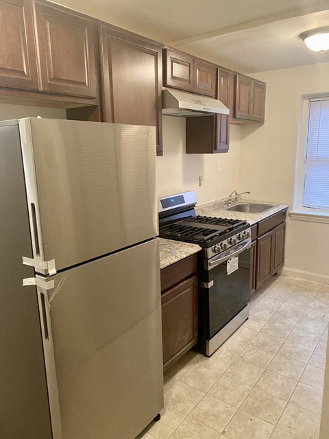 a kitchen with stainless steel appliances and wooden cabinets