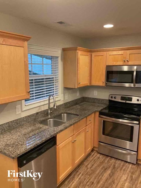 A kitchen with wooden cabinets and stainless steel appliances.