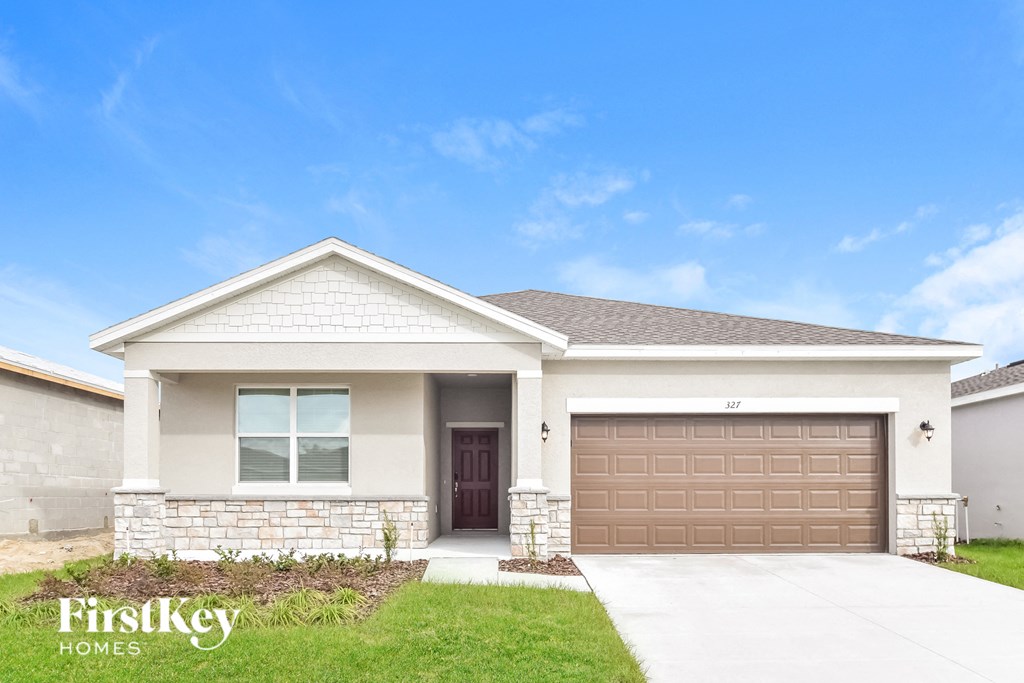 a house with a garage door in front of it