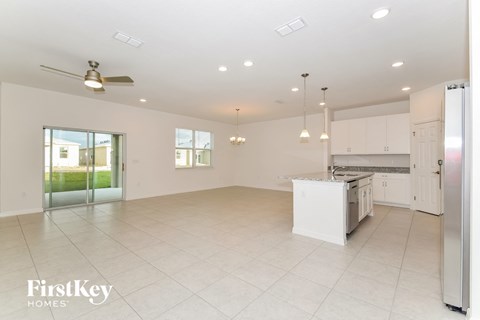 a large kitchen with white cabinets and a white counter top