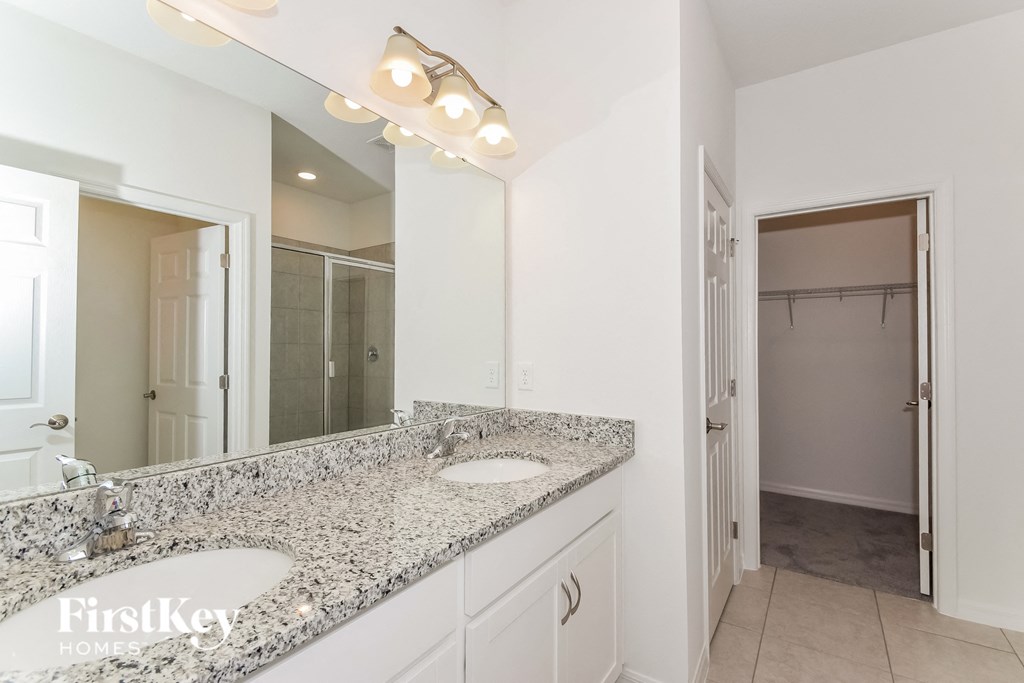 a bathroom with two sinks and a large mirror