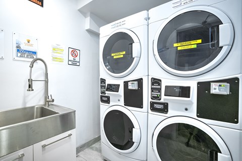 A washing machine and a washing machine with a yellow caution tape on it.