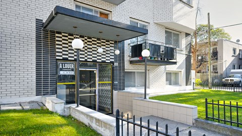 A white building with a black and white checkered awning.