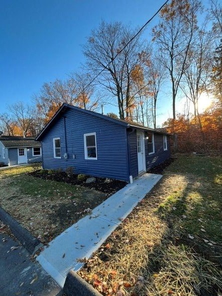 a blue house with a sidewalk in front of it