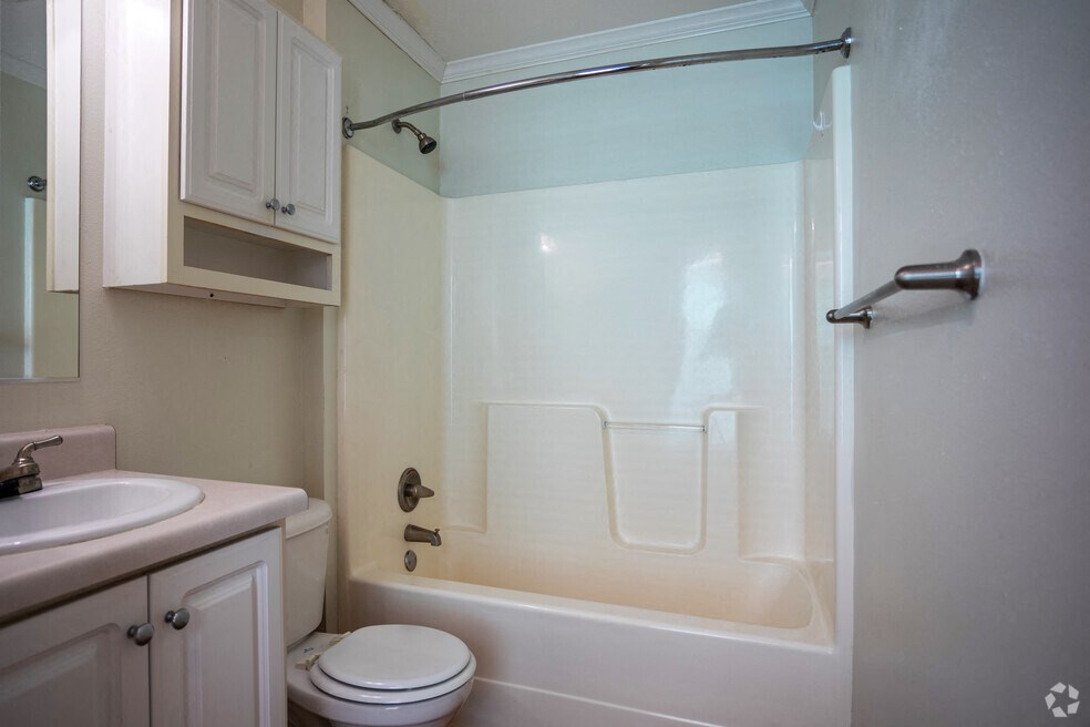a bathroom with a shower and a sink and a toilet