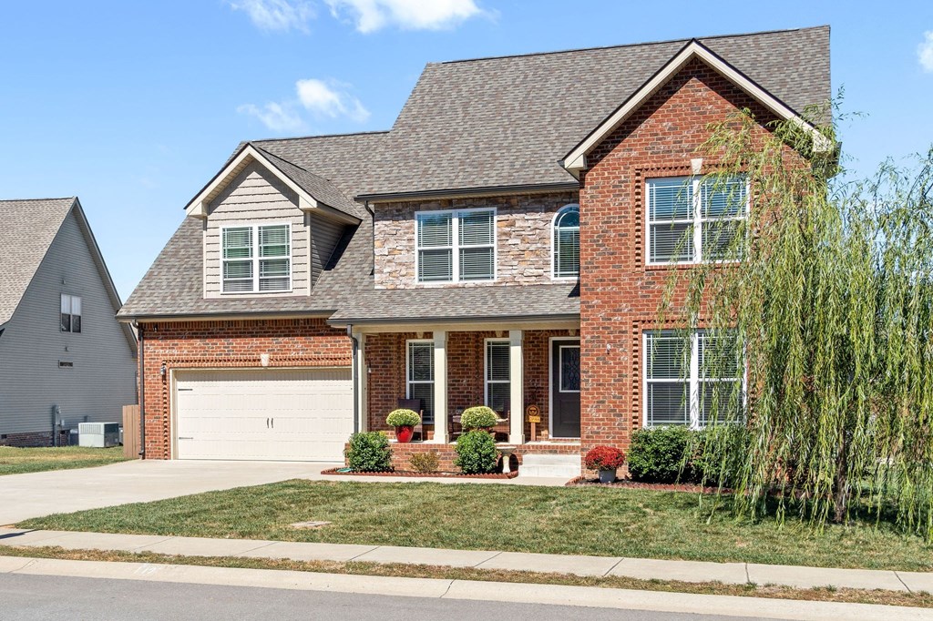 a large brick house with a white garage door