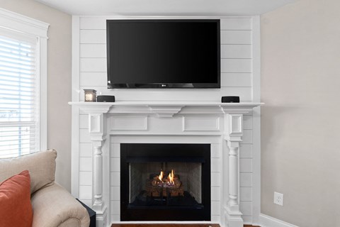 a living room with a fireplace and a tv on top of it