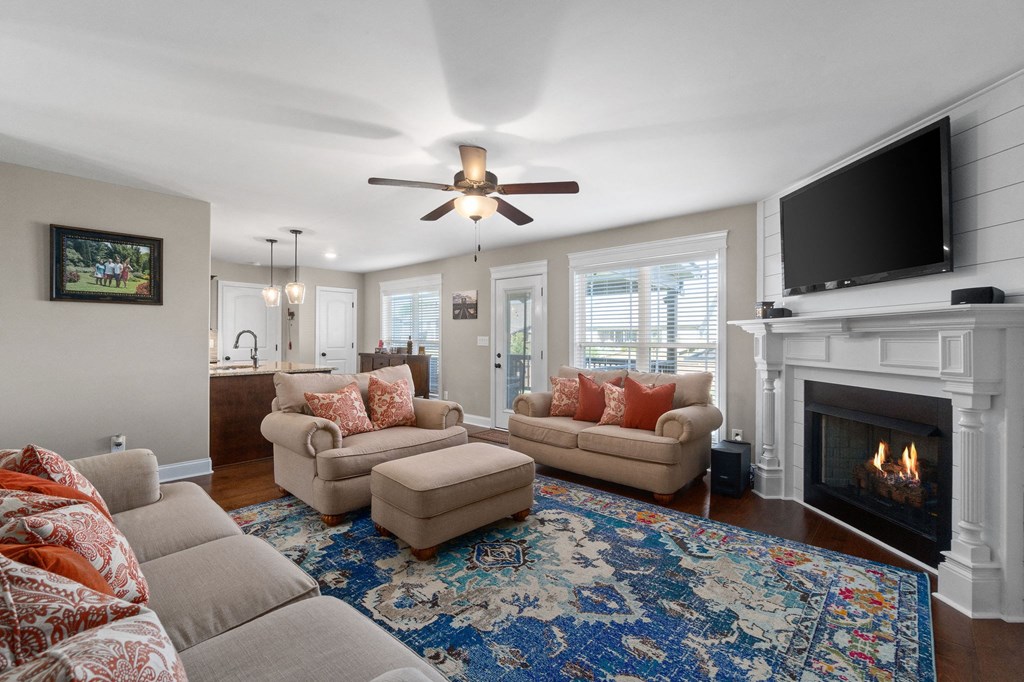 a living room with couches and a tv and a fireplace