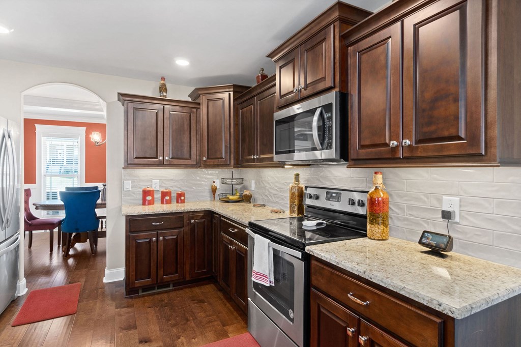 a kitchen with wooden cabinets and stainless steel appliances