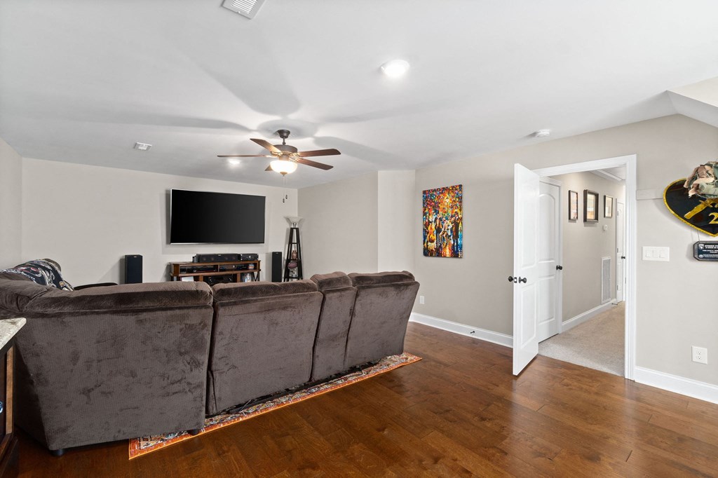 a living room with a couch and a ceiling fan