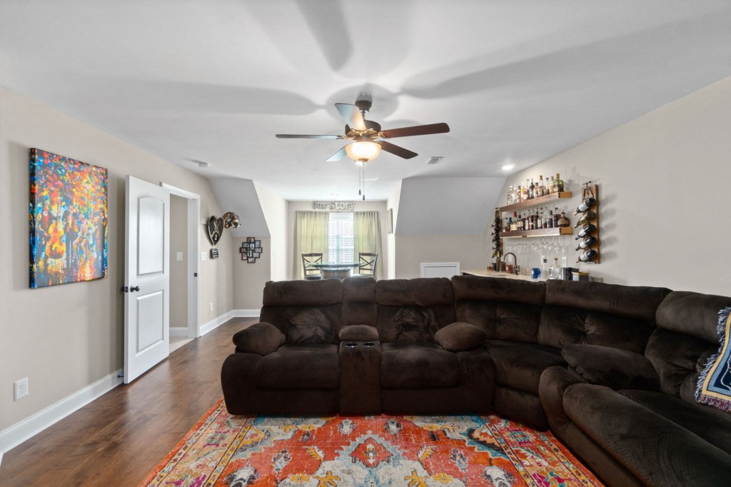 a living room with a couch and a ceiling fan