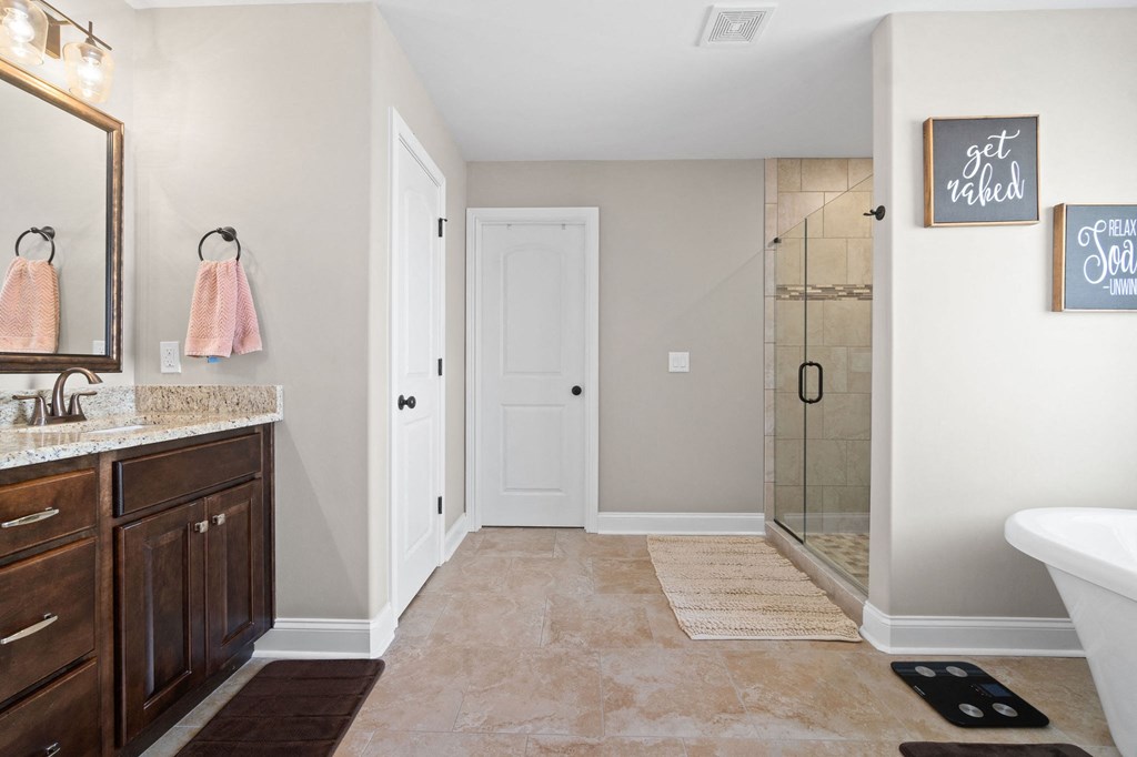 a bathroom with a shower and a sink and a mirror