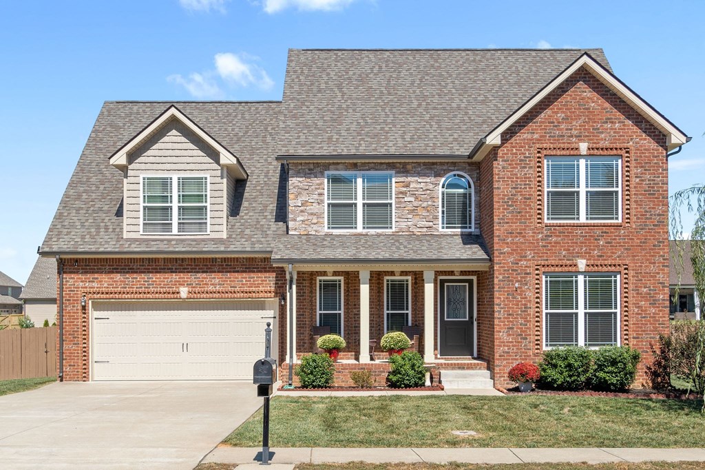 a red brick house with a white garage door