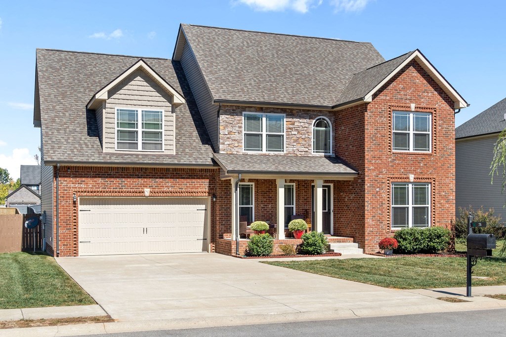 a large brick house with a white garage door
