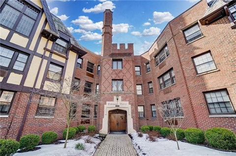 the front of a brick building with a wooden door