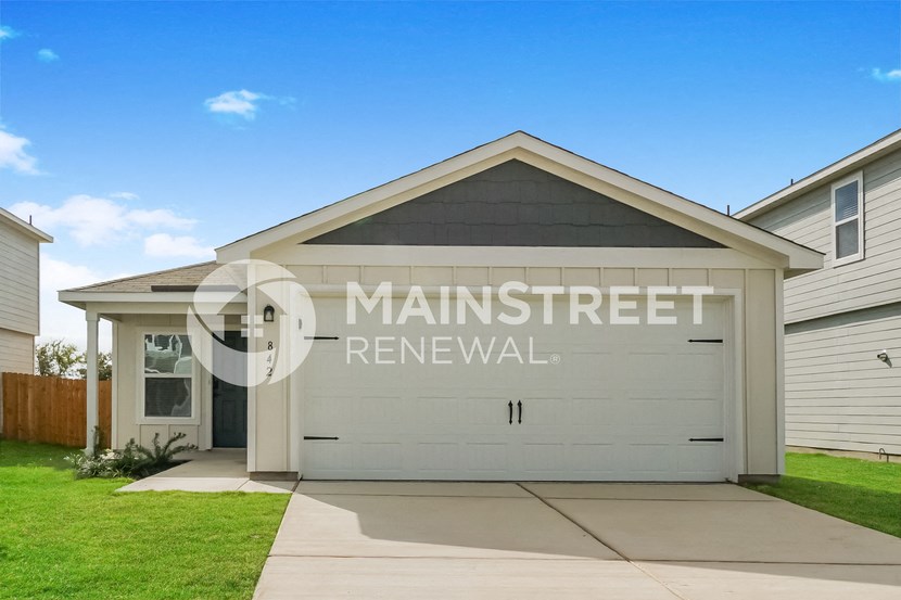 a garage with a white door on the side of a house