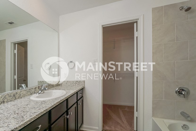 a renovated bathroom with a sink and a mirror