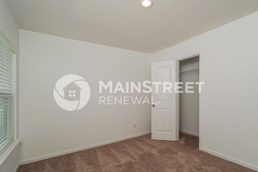 a bedroom apartment with a closet and a door