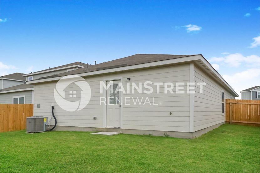 a renovated house with a garage and a lawn