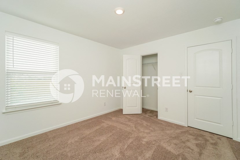 a bedroom with a closet and a white door