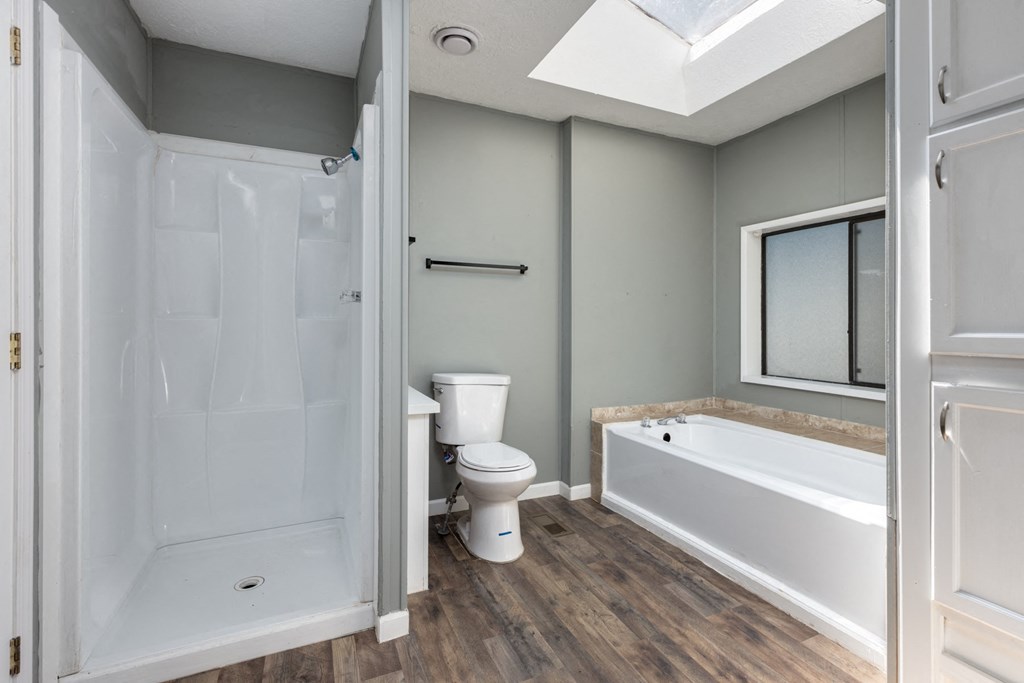 a bathroom with a tub and a toilet and a sink