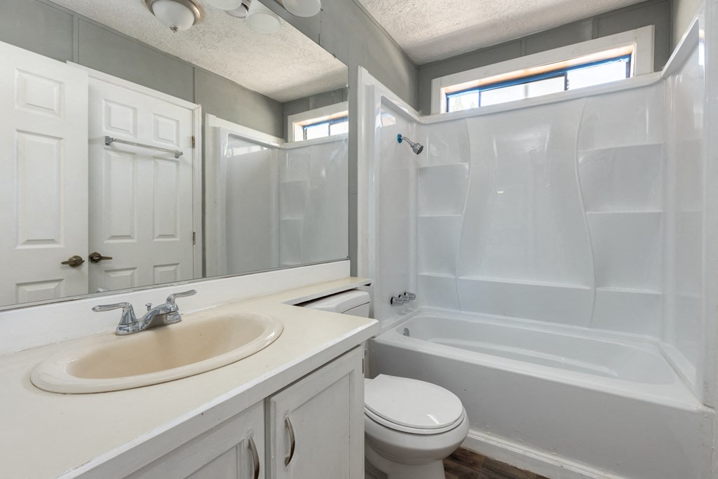 a bathroom with a sink toilet and a shower