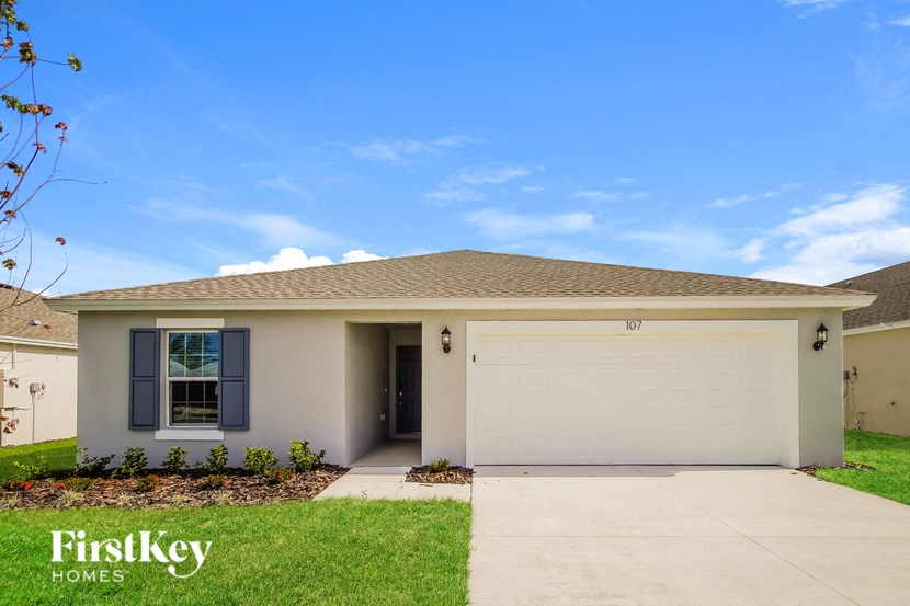 A house with a brown roof and a white garage door.