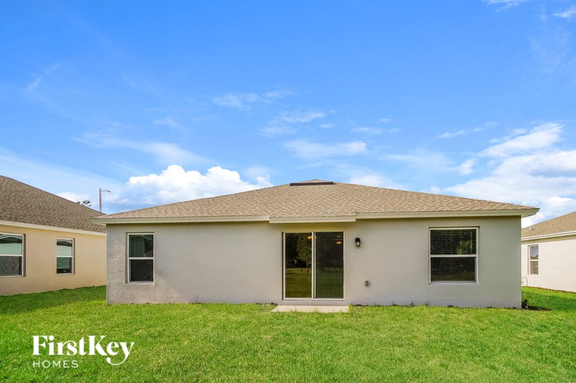 A house with a brown roof and a white wall is shown with the words "FirstKey Homes" on the bottom left.